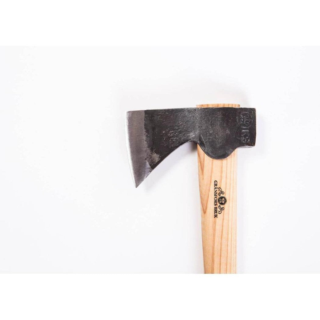 A close-up of the Gransfors Bruk Small Hatchet with a light wooden handle and a dark charcoal-colored axe head against a plain white background.