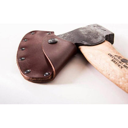A close-up of the Gransfors Bruk Swedish Carving Axe - Double Bevel with its brown leather sheath, showing the axe head and wooden handle against a white background.