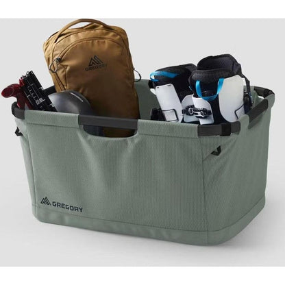 A front view of the Nomad Green Gregory Alpaca Gear Basket 70 filled with gear against a white background.