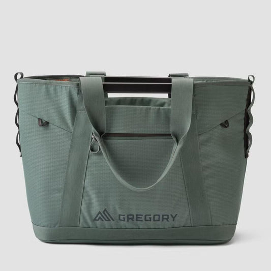 A front view of the Gregory Alpaca Utility Tote 50L in Nomad Green with a zippered pocket and logo visible against a plain background.