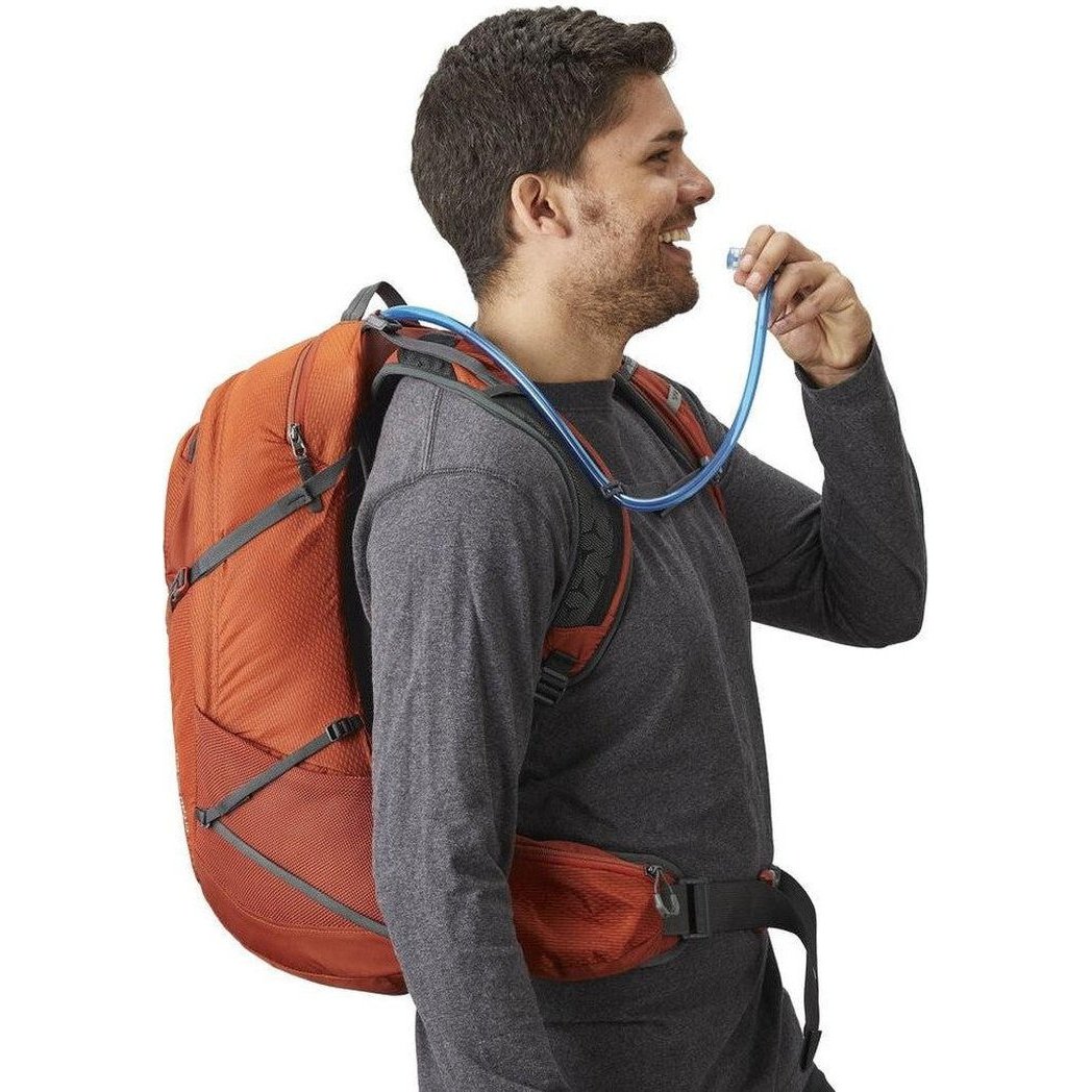 Side view of the Gregory Citro 30 H20 in Spark Orange showing the hydration tube and orange backpack against a white background.