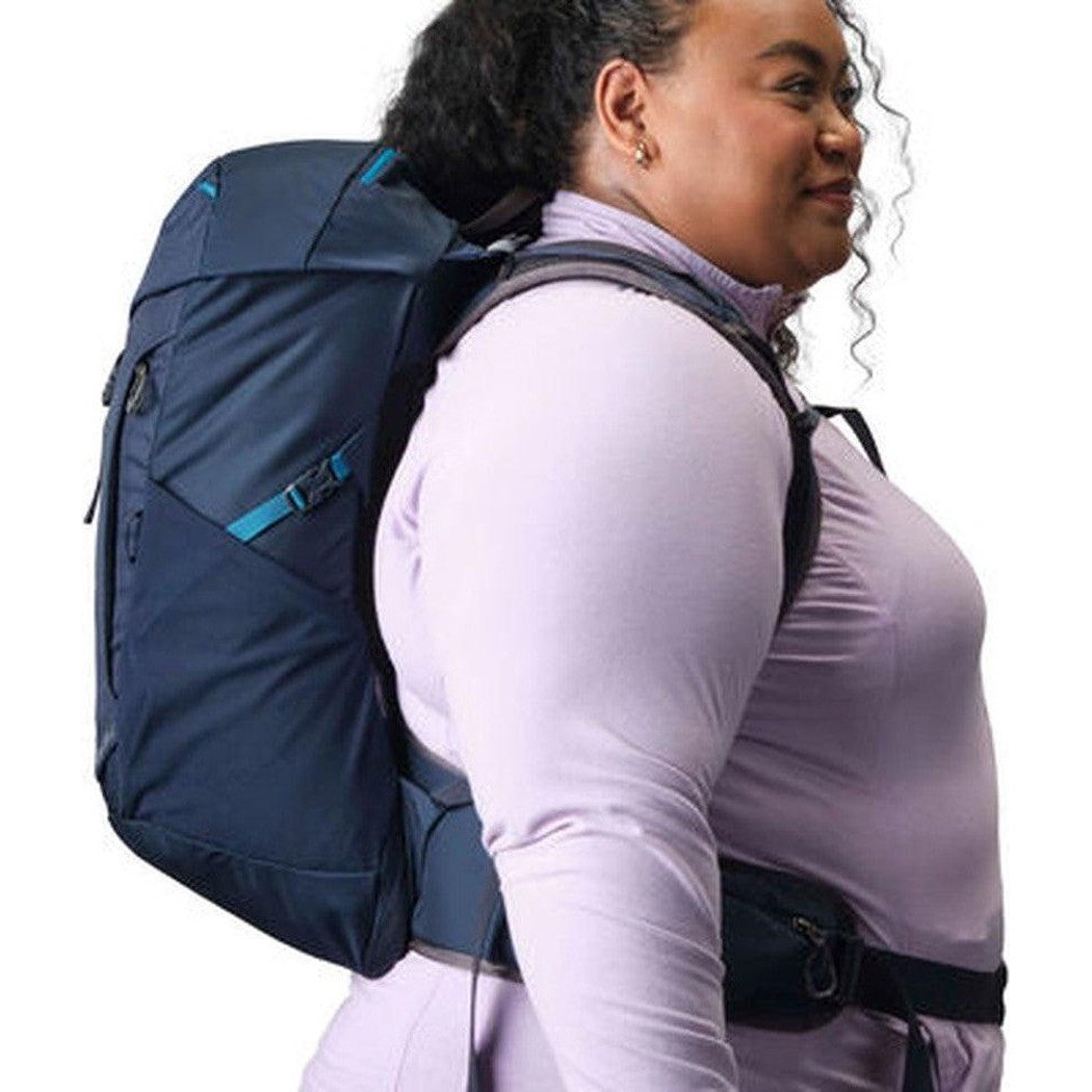 Side view of the Gregory Jade 28 LT Plus in Midnight Navy showing the model wearing it against a white background.