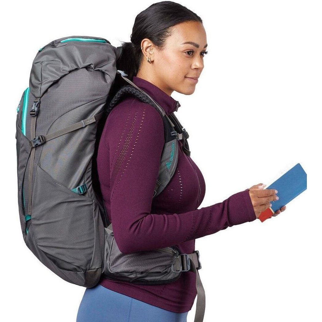 Side view of the Gregory Jade 43 backpack in Mist Grey showing the large main compartment and a model wearing it against a white background.