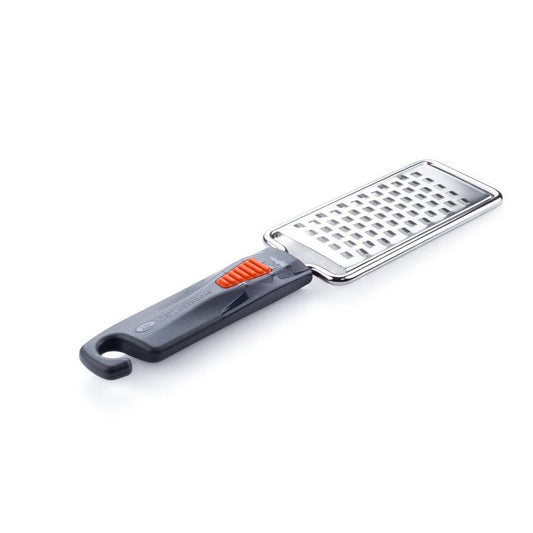 A side view of the GSI Outdoors Pack Grater with a charcoal handle and orange accent against a white background.