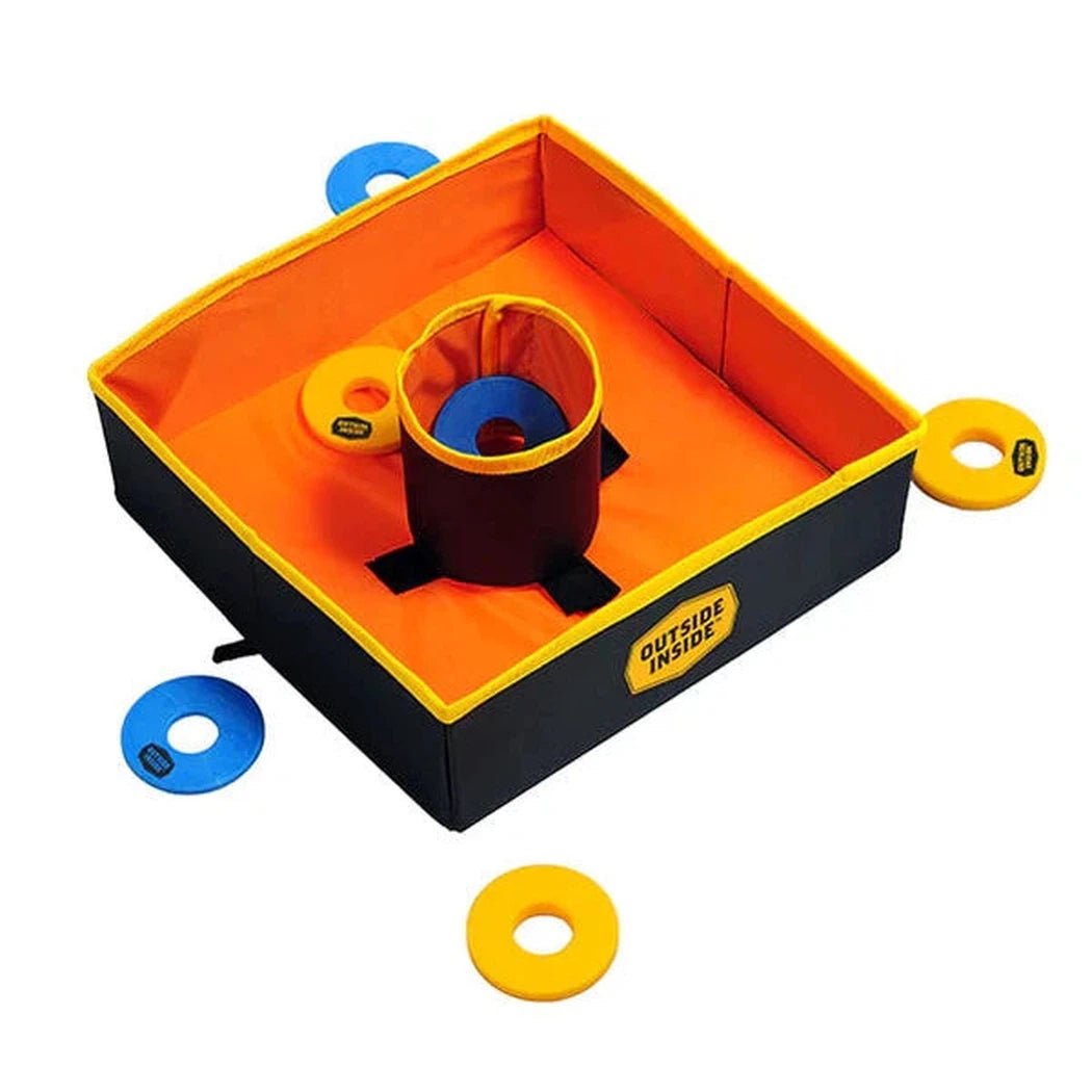 A top-down view of the GSI Outdoors Travel Washer Toss game with orange interior and black exterior, showing blue and yellow washers scattered around.