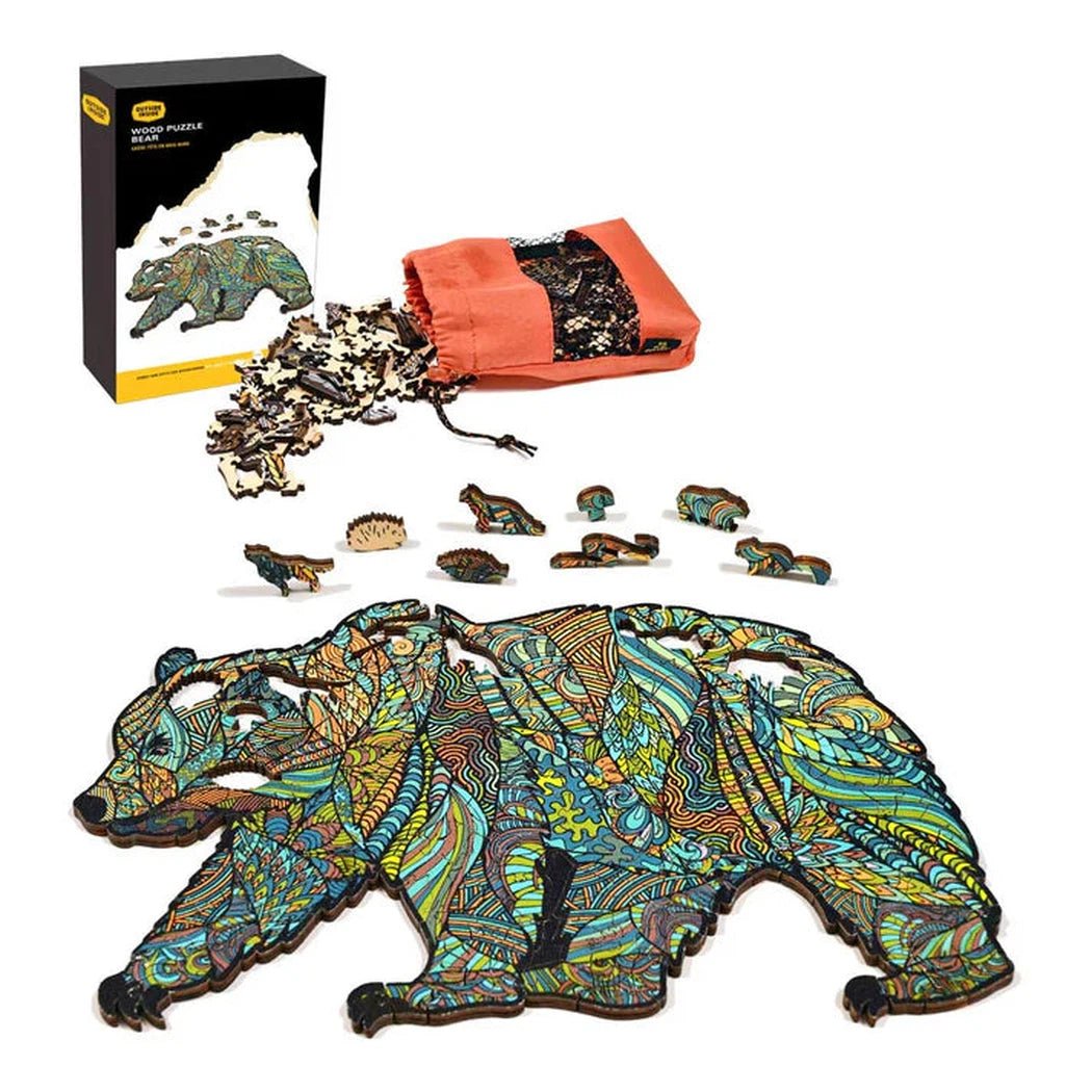 A GSI Outdoors Wood Puzzle Bear in Charcoal/Graphite color laid out with puzzle pieces and a red storage bag visible.