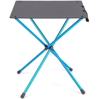 A top-down view of the Helinox Cafe Table in Black with blue legs and a foldable design against a white background.