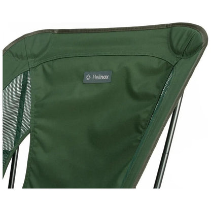 A close-up of the Helinox Chair One in Black showing the brand label and mesh side panel.