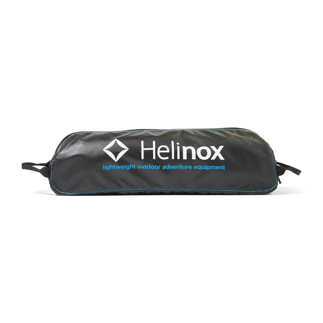 A black Helinox Table One Hard Top bag with blue accents and white text sits on a white background.