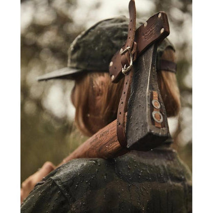 Back view of the Helko Werk Black Forest Woodworker axe with leather strap, worn by a model in a forest background.