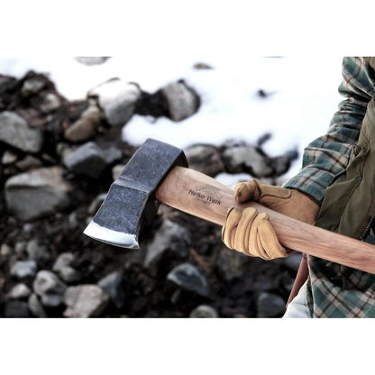 A person wearing tan gloves holds the Helko Werk Saxon Splitter axe with a snowy, rocky background.