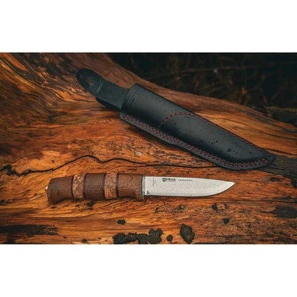 A close-up of the Helle Harding Rubin Knife - 2026 Ltd Edition on a wooden surface with its black sheath.