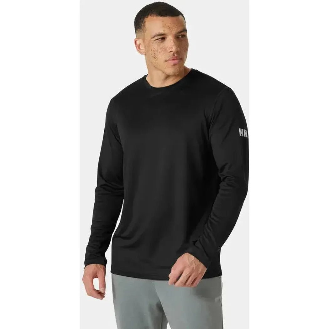 A front view of the Helly Hansen Men's HH Tech Crew Long Sleeve 2.0 in Ebony on a model wearing gray pants against a white background.