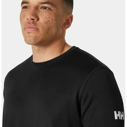 A man wearing the Helly Hansen Men's HH Tech Crew Long Sleeve 2.0 in Ebony is shown from the side against a plain white background.