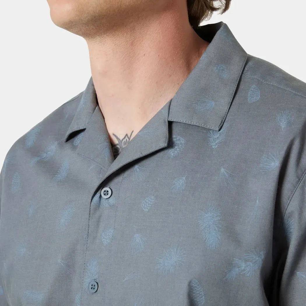 A close-up of the Helly Hansen Men's Holmen Short Sleeve Shirt in Washed Navy/Pine Needle, showing the collar and buttons against a plain white background.