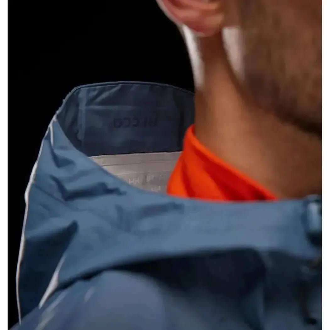 Back view of the Helly Hansen Men's Loke Jacket 2.0 in Alpine Frost showing the collar and orange shirt against a dark background.