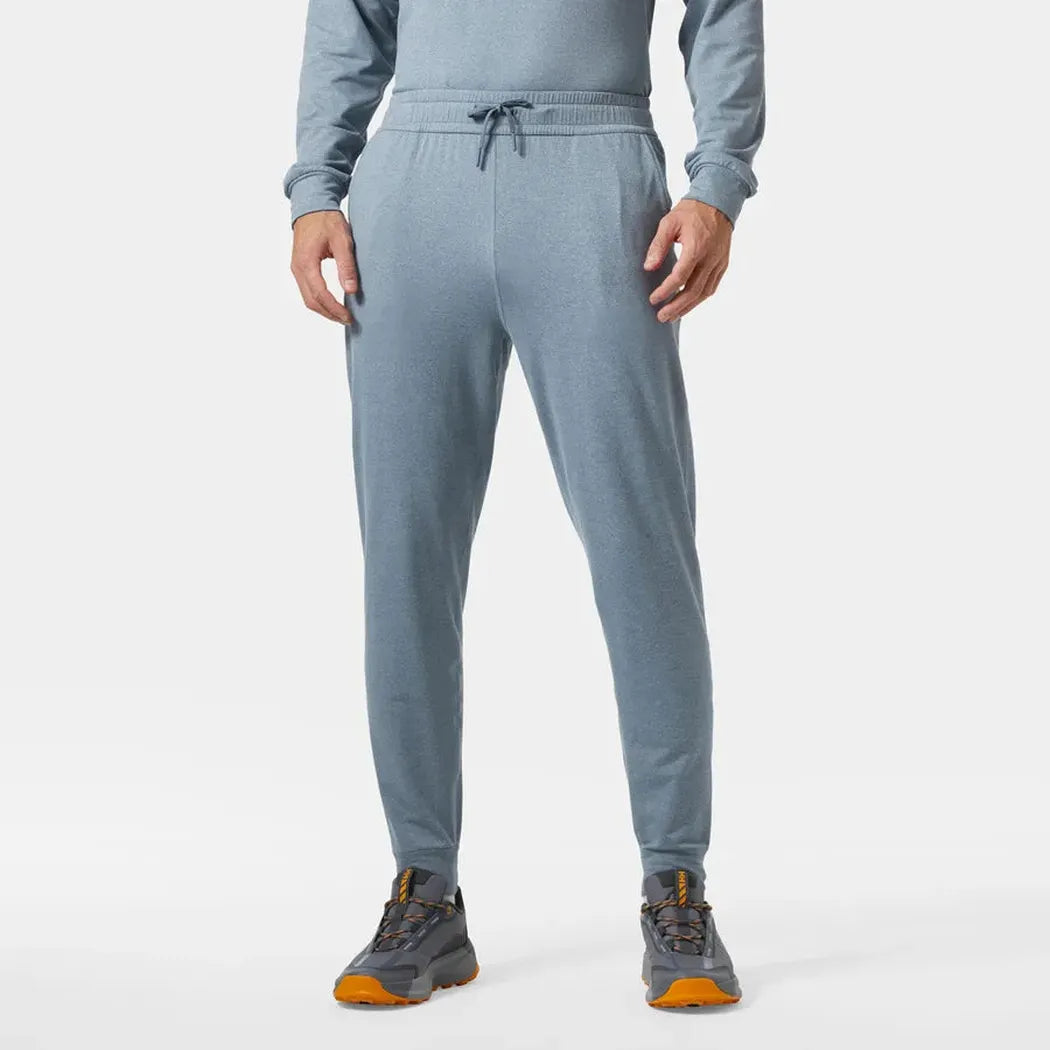 A front view of the Helly Hansen Men's Tyri Knit Joggers in Washed Navy, showing the drawstring waist and model wearing them against a plain white background.