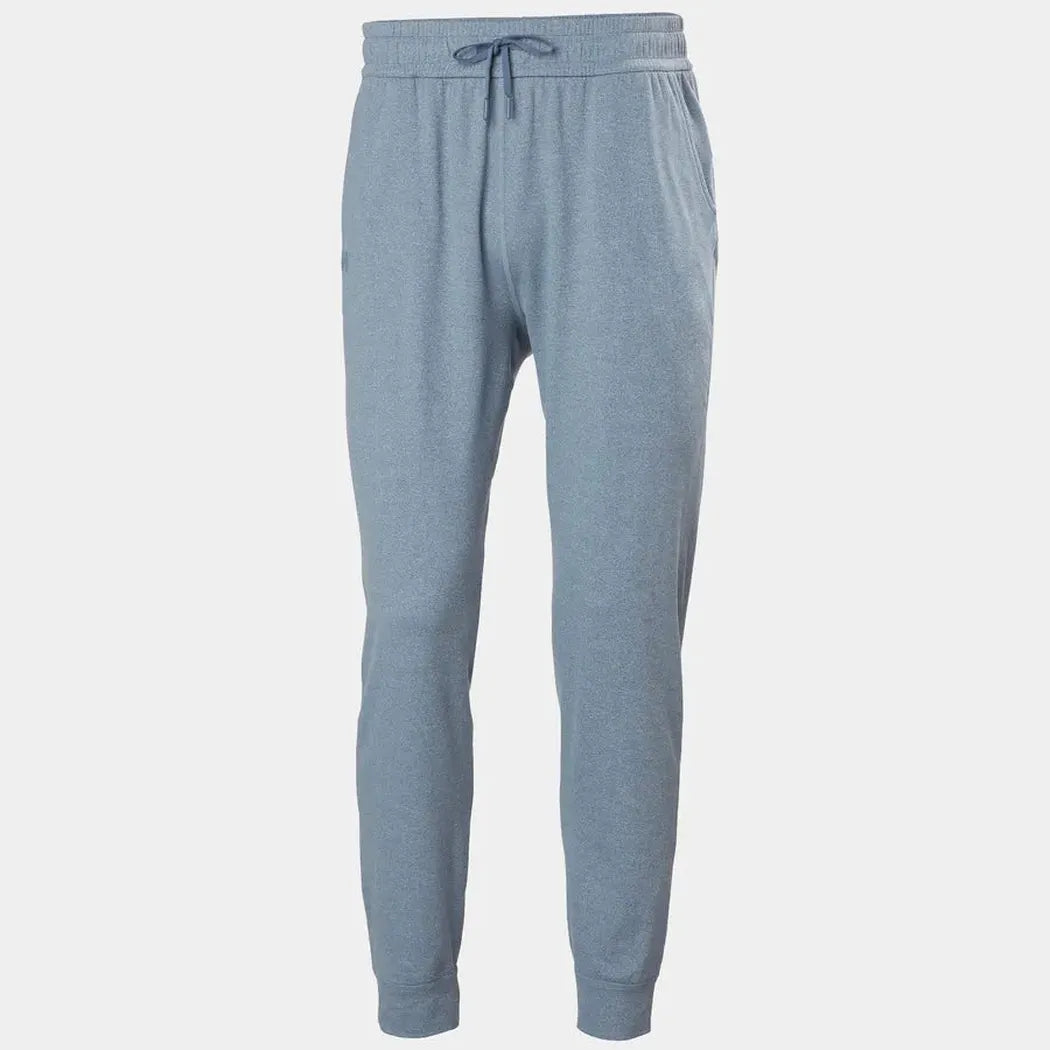 Side view of the Helly Hansen Men's Tyri Knit Joggers in Washed Navy showing the drawstring waist and cuffed ankles against a plain white background.