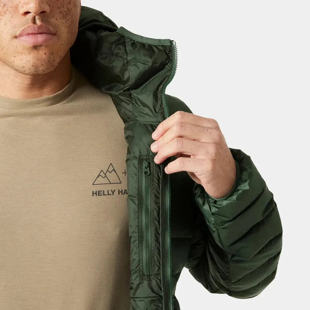 A man wearing a Jungle Green Helly Hansen Men's Verglas Hooded Down Jacket 2.0 with the hood up, showing the inner lining and zipper against a plain white background.