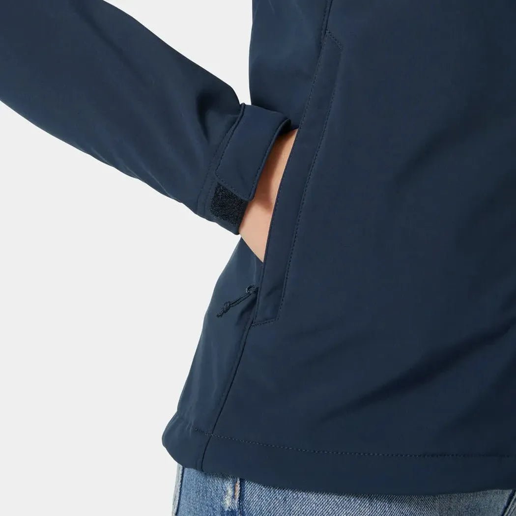 Side view of the Helly Hansen Women's Paramount Hood Softshell Jacket in Navy showing the side pocket and model wearing it against a white background.