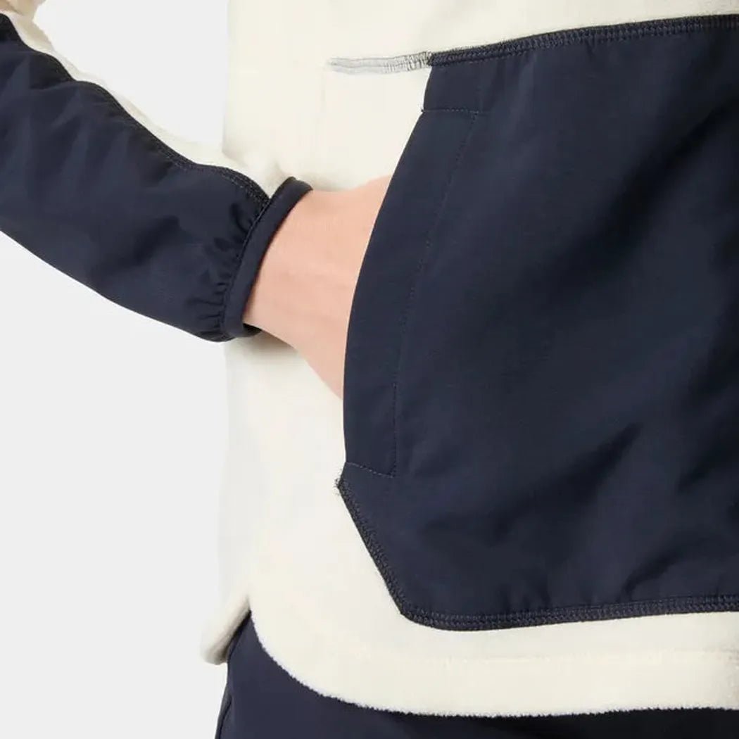 Side view of the Helly Hansen Women’s Rig Fleece Jacket in Cream showing the pocket and elasticized sleeve cuff against a plain white background.