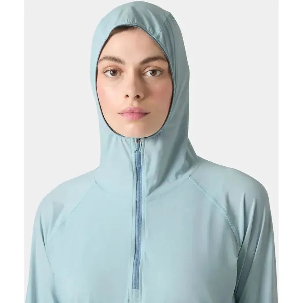 A front view of the Helly Hansen Women's Shine Solen Half-Zip Sun Hoodie in Barely Blue with a zippered hood against a plain background.