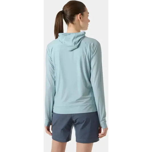 Back view of the Helly Hansen Women's Shine Solen Half-Zip Sun Hoodie in Barely Blue on a model wearing dark shorts against a plain background.