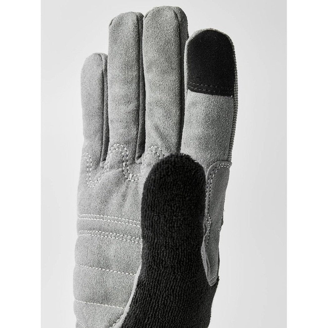 A close-up of the Hestra Job Beta Touch grey work glove showing the textured palm and black touch-sensitive fingertip against a plain background.