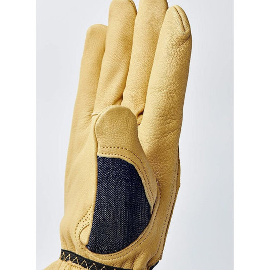 A close-up of the Hestra Job Kobolt Denim work glove showing the indigo padded palm patch against a light background.