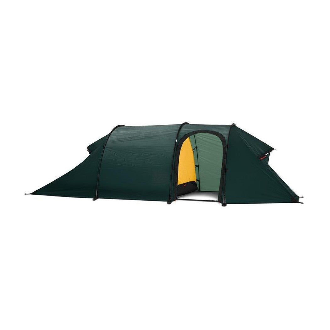 Side view of the Hilleberg Nammatj 2 GT green tent showing the entrance and a white background.