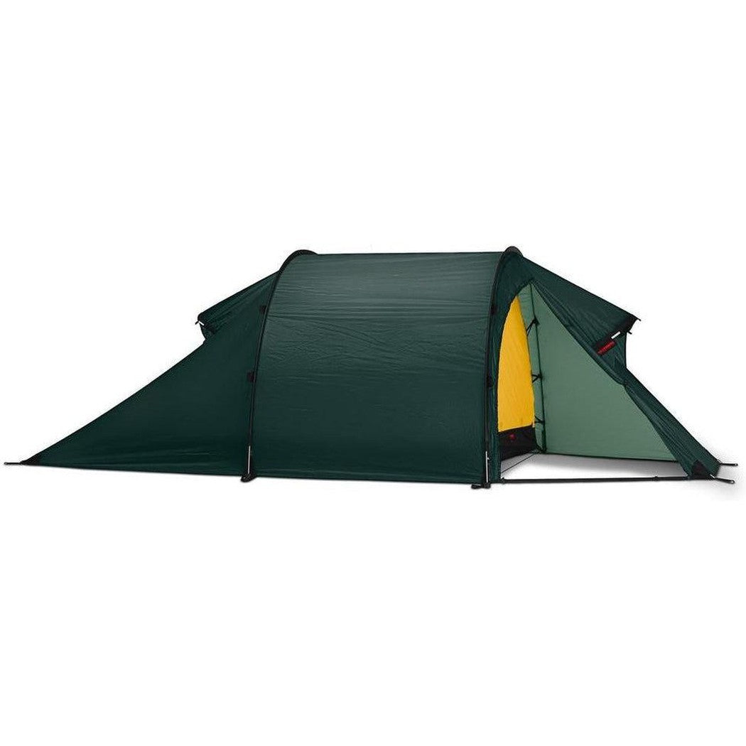 Side view of the Hilleberg Nammatj 3 green tent showing the entrance and a white background.