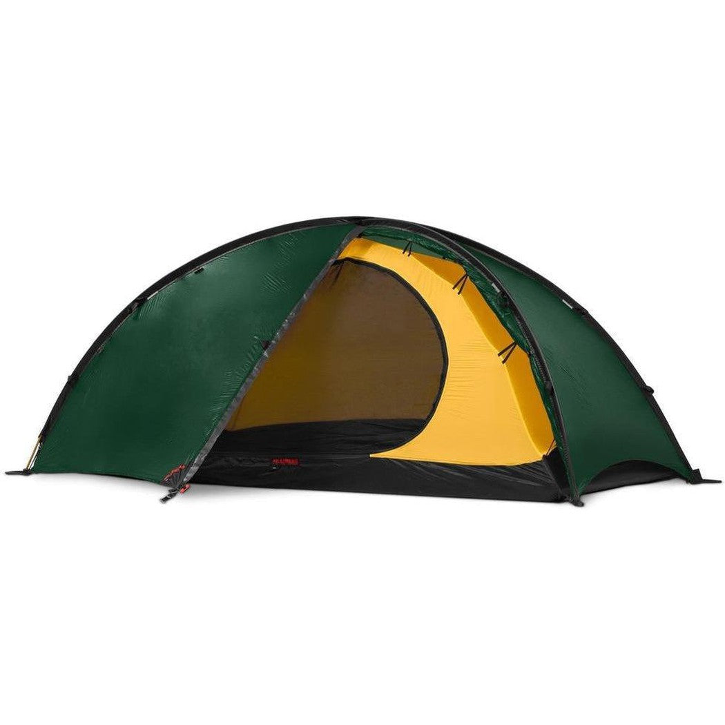 A front view of the Hilleberg Niak tent in Green with a yellow interior and black floor, set against a white background.