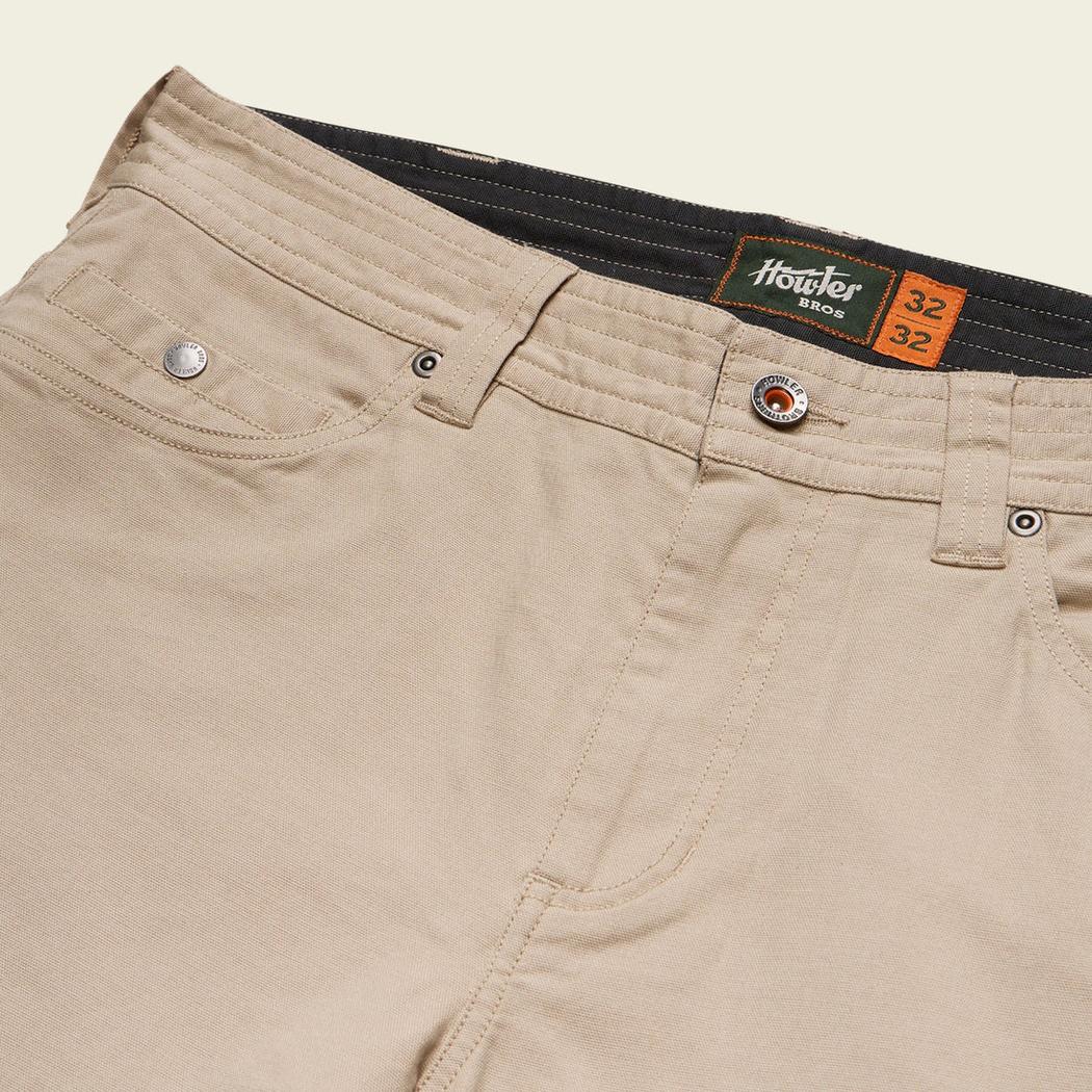 A close-up of the Howler Brothers Frontside 5-Pocket Pants in Faded Khaki showing the waistband and pocket details.