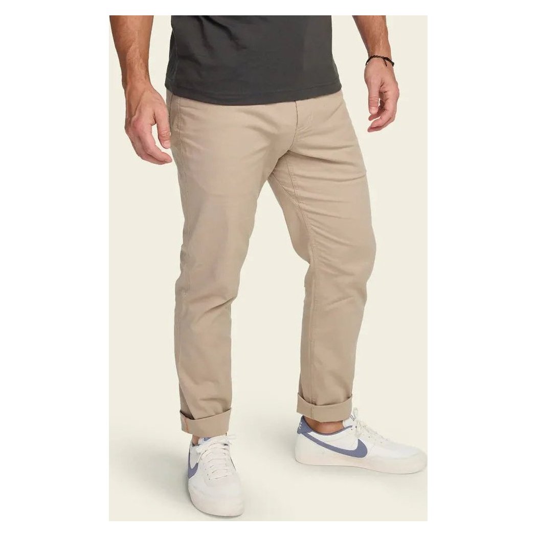 A front view of the Howler Brothers Frontside 5-Pocket Pants in Faded Khaki, showing rolled cuffs and a model wearing them against a plain background.