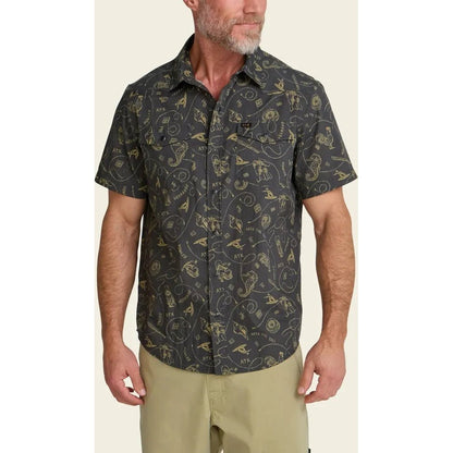 A front view of the Howler Brothers Men's H Bar B Snapshirt in Bouquets: Morel on a model wearing khaki shorts against a neutral background.