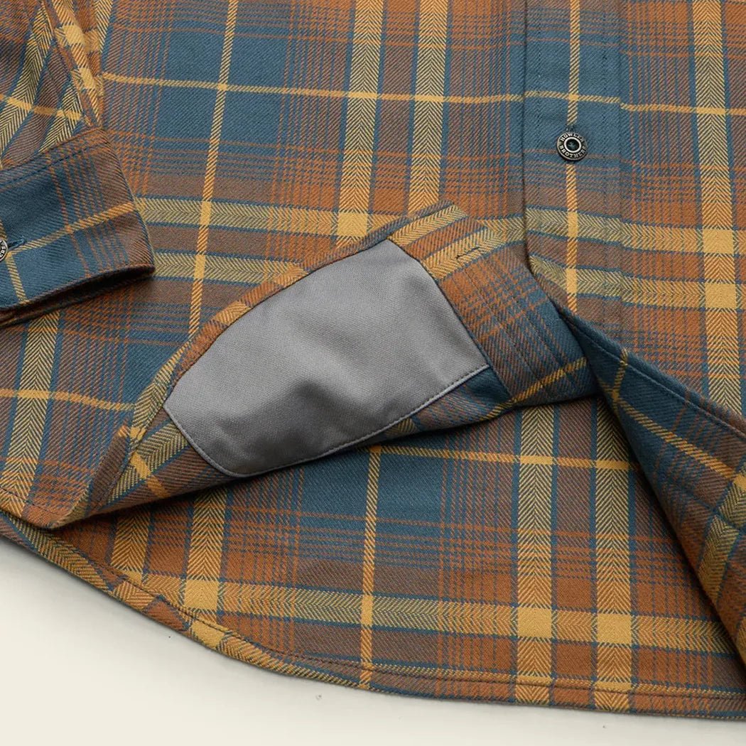 A close-up of the Howler Brothers Men's Harker Flannel in Kempton Plaid : Stargazer showing the charcoal elbow patch and button placket.