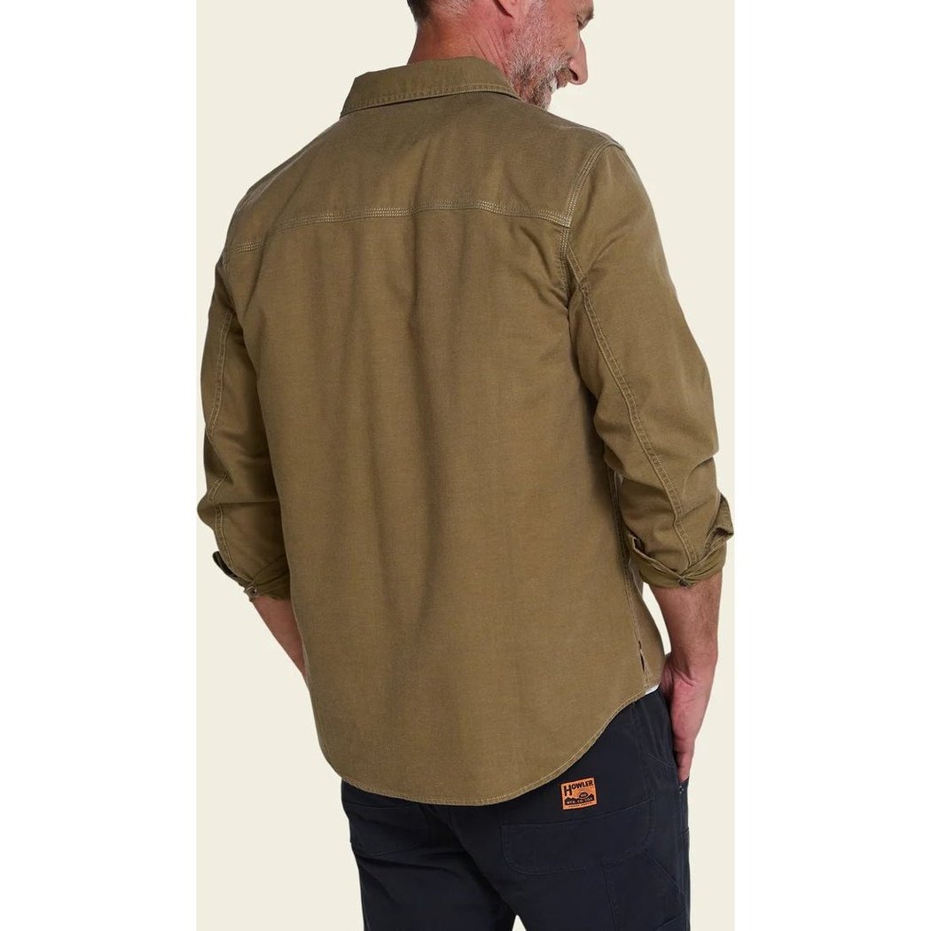 Back view of the Howler Brothers Mens HB Trade Shirt Long Sleeve in Anthracite, showing the model wearing it with dark pants and a plain background.