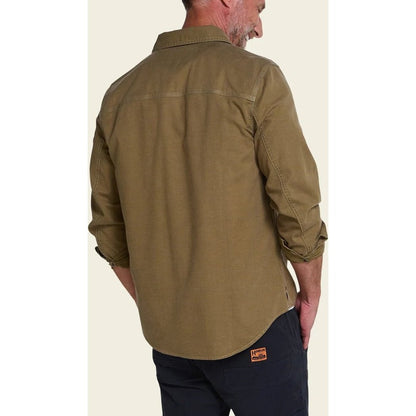 Back view of the Howler Brothers Mens HB Trade Shirt Long Sleeve in Anthracite, showing the model wearing it with dark pants and a plain background.