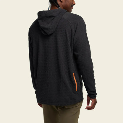 Back view of the Howler Brothers Men's Palo Duro Fleece Hoodie in Antique Black with an orange zipper pocket, on a model against a plain background.