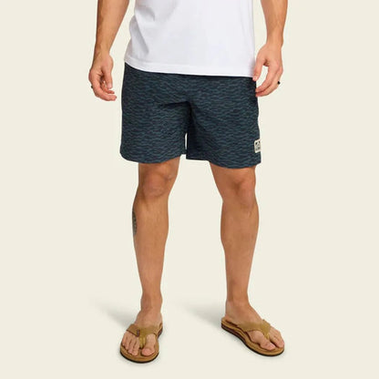 A front view of the Howler Brothers Men's Pressure Drop Cord Shorts - Canyon Distortion in Media Noche, showing the model wearing them with a plain white background.