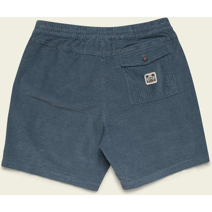 Back view of the Howler Brothers Men's Pressure Drop Cord Shorts in Grid : Blue Mirage showing the back pocket with a logo and elastic waistband against a light background.