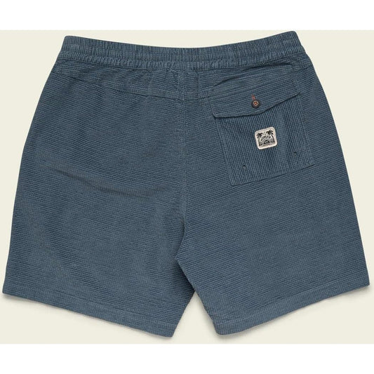 Back view of the Howler Brothers Men's Pressure Drop Cord Shorts in Grid : Blue Mirage showing the back pocket with a logo and elastic waistband against a light background.