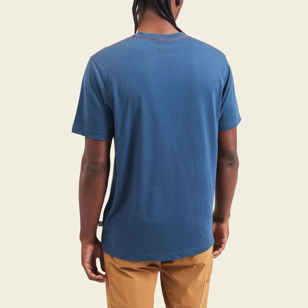 Back view of the Howler Brothers Select T in Elements : Antique Black on a model wearing tan pants against a light background.