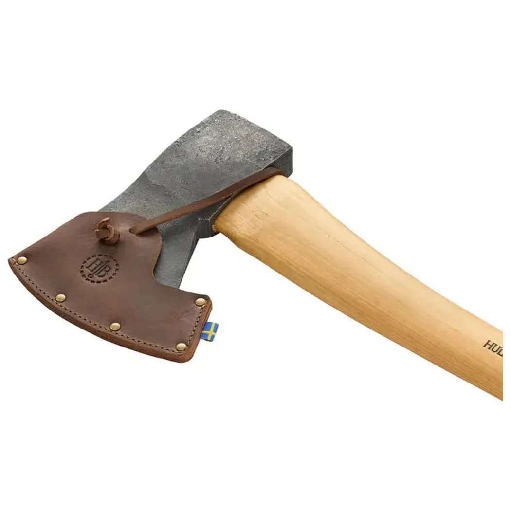 A side view of the Hults Bruk Jursla Felling Axe with a natural wooden handle and a charcoal-colored head, showing the leather sheath against a white background.
