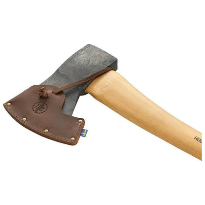 A side view of the Hults Bruk Jursla Felling Axe with a natural wooden handle and a charcoal-colored head, showing the leather sheath against a white background.