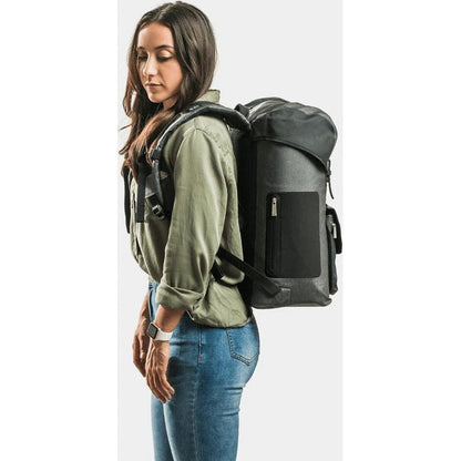 Side view of the IceMule Coolers Urbano 30L in Snow Grey showing the front pocket and model wearing it against a white background.