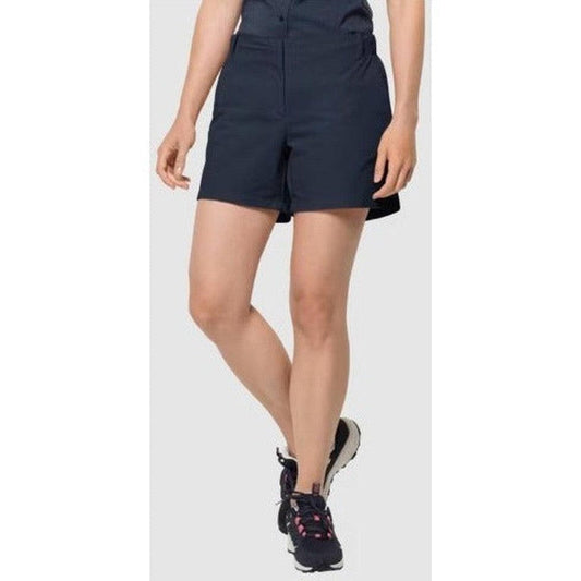 A front view of the Jack Wolfskin Women's Pack & Go Shorts in Night Blue on a model wearing black sneakers against a plain white background.