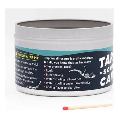 A round white JD and Kate Industries Tar Pit Scented Candle with a teal and black label, showing practical uses of tar, sits against a white background with a matchstick nearby.