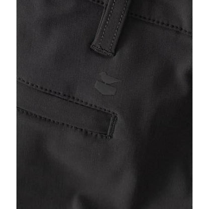 A close-up of the Jetty Men's Acadia Versatility Short in Black Sand showing the front pocket and brand logo.