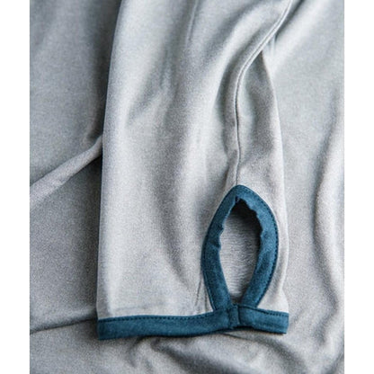 A close-up of the Jetty Men's Mahi UV Tech Hoodie in Grey showing the grey fabric and blue trim on the sleeve cuff.